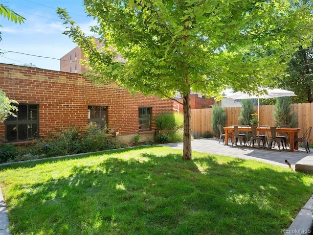 view of yard featuring fence and a patio