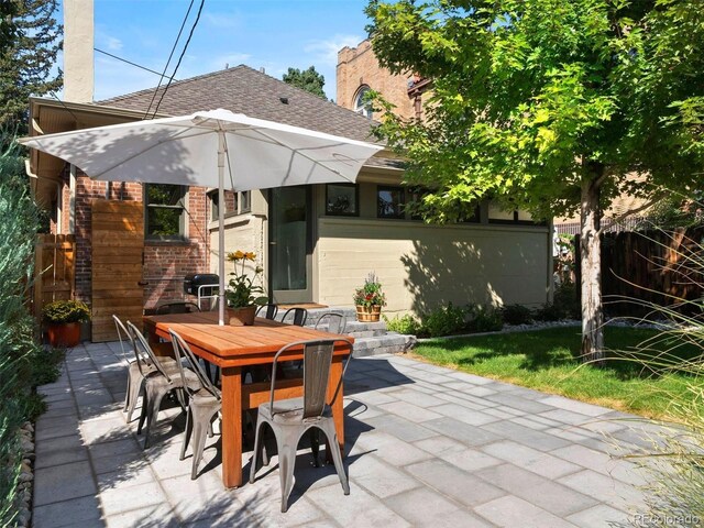 view of patio / terrace featuring fence and outdoor dining space