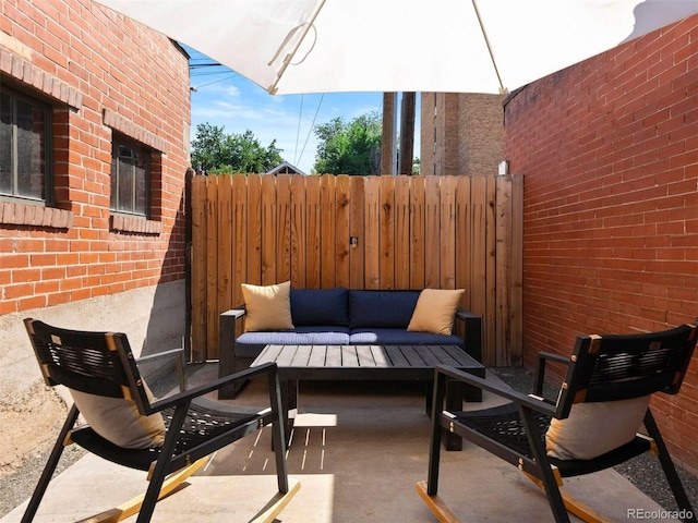 view of patio / terrace featuring an outdoor hangout area and fence