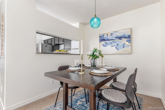 dining room with carpet and baseboards