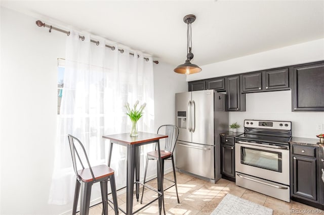 kitchen featuring light tile patterned flooring, appliances with stainless steel finishes, and pendant lighting