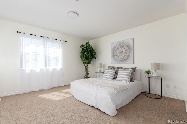 carpeted bedroom featuring baseboards