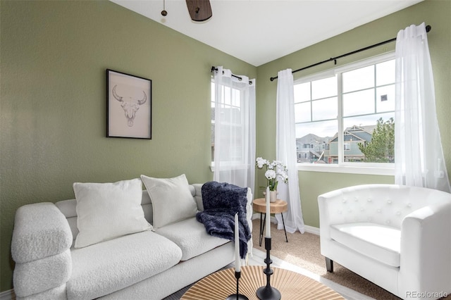 carpeted living area with baseboards