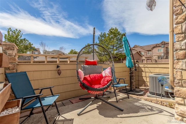 view of patio / terrace with fence and central AC