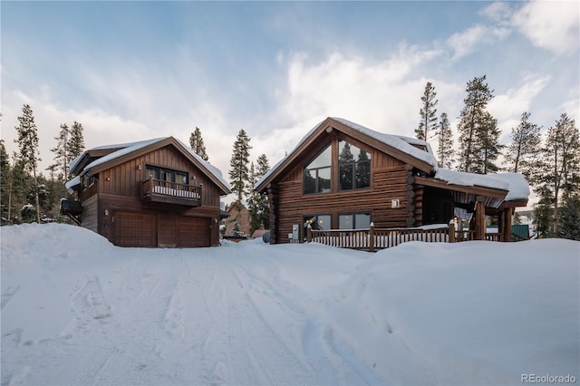 log-style house featuring a garage