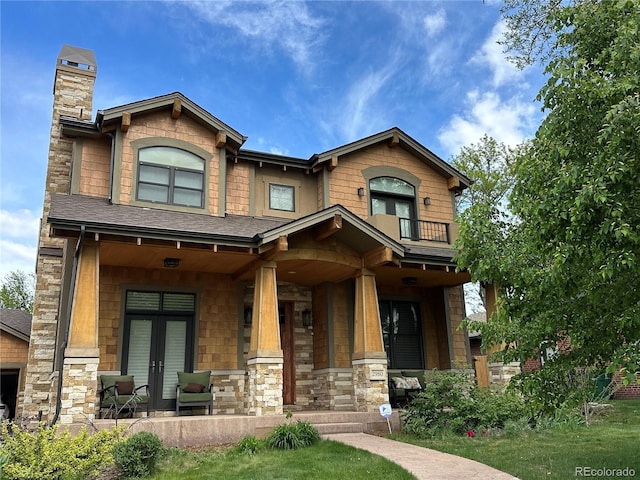 2980 S Adams St, Denver, CO 80210 - craftsman house with covered porch, french doors, a chimney, stone siding, and a balcony