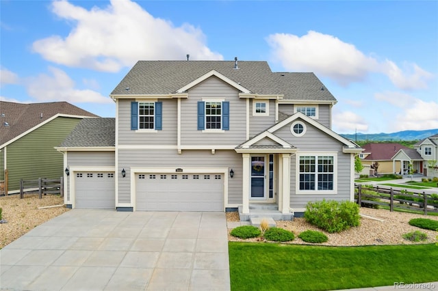19316 W 84th Pl, Arvada, CO 80007 - traditional-style house featuring concrete driveway, a mountain view, a shingled roof, and an attached garage