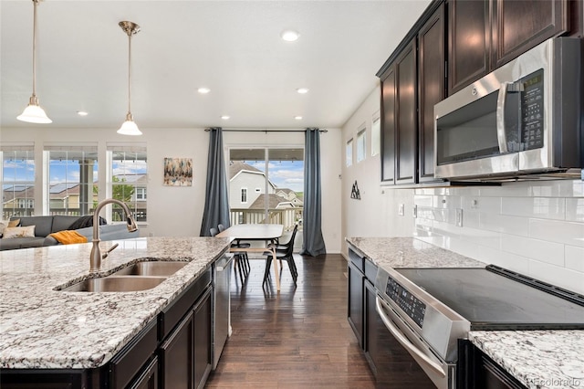 19316 W 84th Pl, Arvada, CO 80007 - kitchen with appliances with stainless steel finishes, a sink, healthy amount of natural light, dark wood finished floors, and recessed lighting
