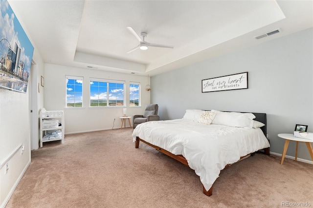 19316 W 84th Pl, Arvada, CO 80007 - carpeted bedroom featuring a raised ceiling, baseboards, and ceiling fan