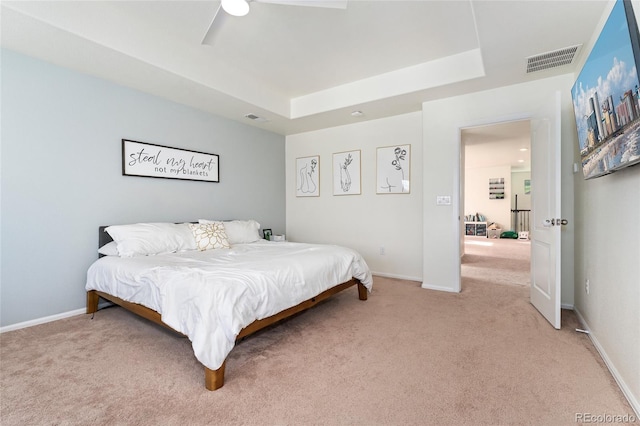 19316 W 84th Pl, Arvada, CO 80007 - bedroom featuring light colored carpet, a raised ceiling, a ceiling fan, and baseboards