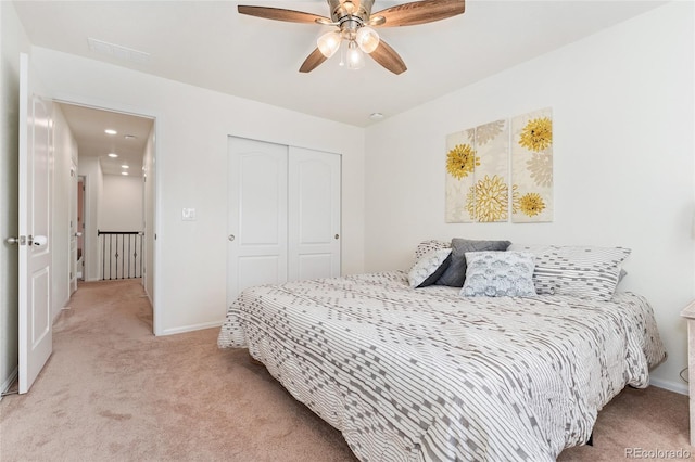 19316 W 84th Pl, Arvada, CO 80007 - bedroom with light colored carpet, a closet, baseboards, and ceiling fan
