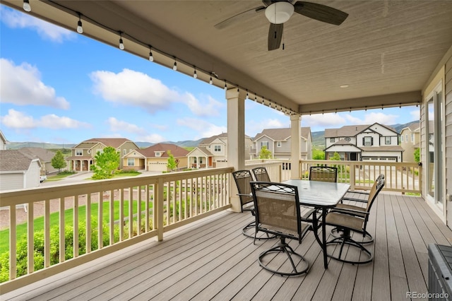 19316 W 84th Pl, Arvada, CO 80007 - wooden deck featuring a residential view, ceiling fan, and outdoor dining space
