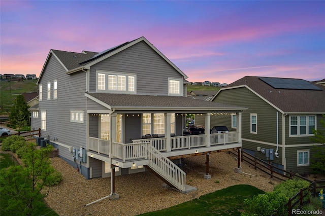 19316 W 84th Pl, Arvada, CO 80007 - back of property at dusk featuring a shingled roof and a deck
