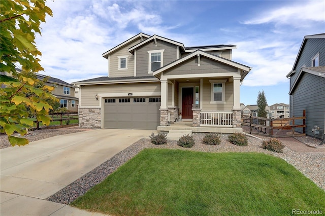 craftsman inspired home featuring a front lawn, covered porch, and a garage