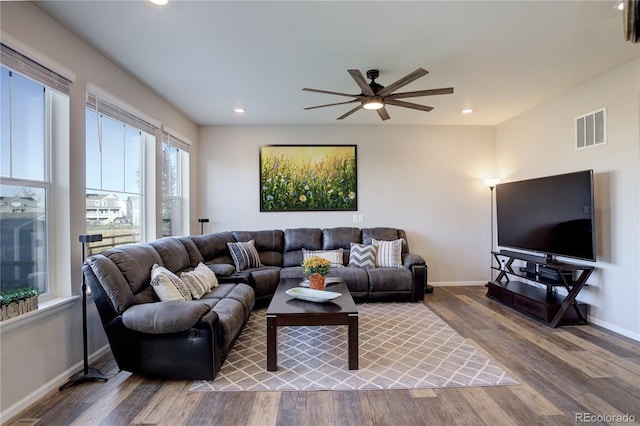 living room featuring hardwood / wood-style flooring and ceiling fan