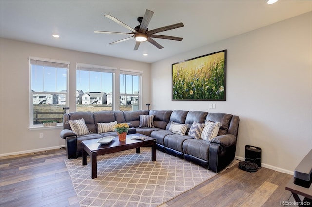 living room featuring light hardwood / wood-style floors and ceiling fan