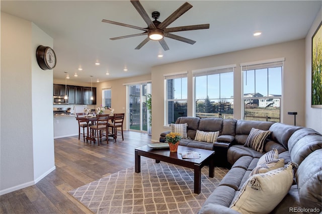 living room with hardwood / wood-style floors, ceiling fan, and a wealth of natural light