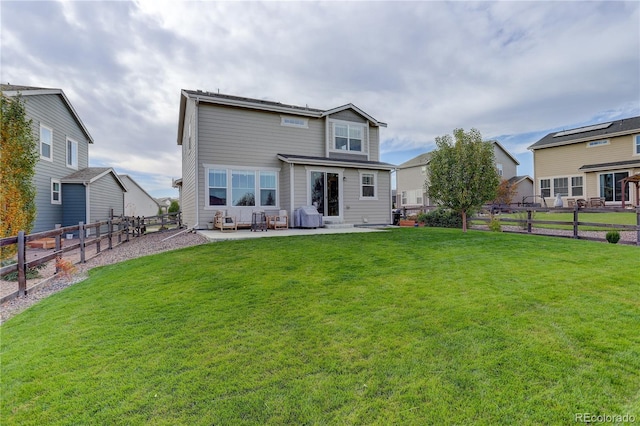 rear view of house with a patio area and a yard