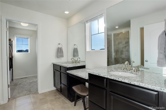 bathroom with tile patterned floors, vanity, and a shower with shower door