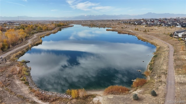 drone / aerial view featuring a water and mountain view