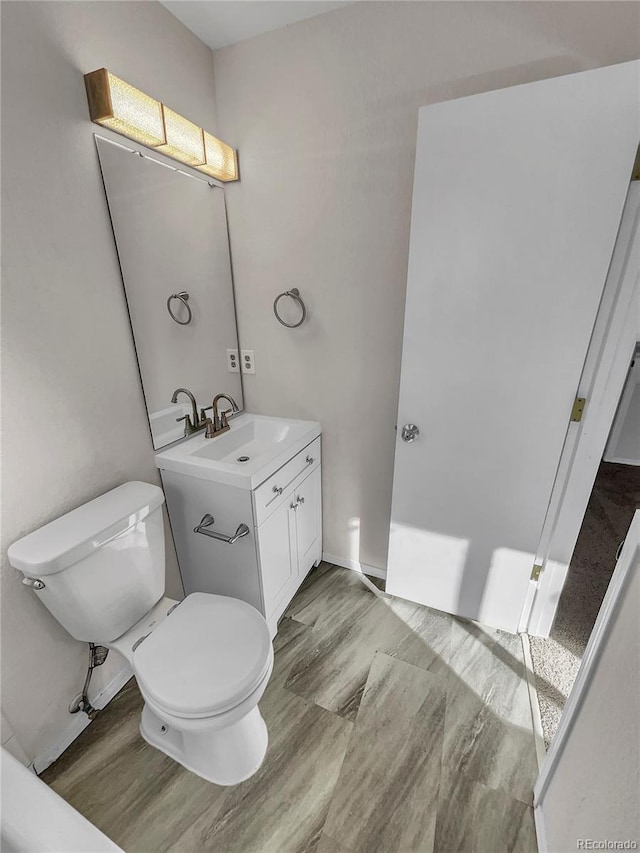 bathroom with toilet and vanity