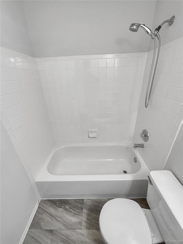 bathroom with toilet and bathing tub / shower combination