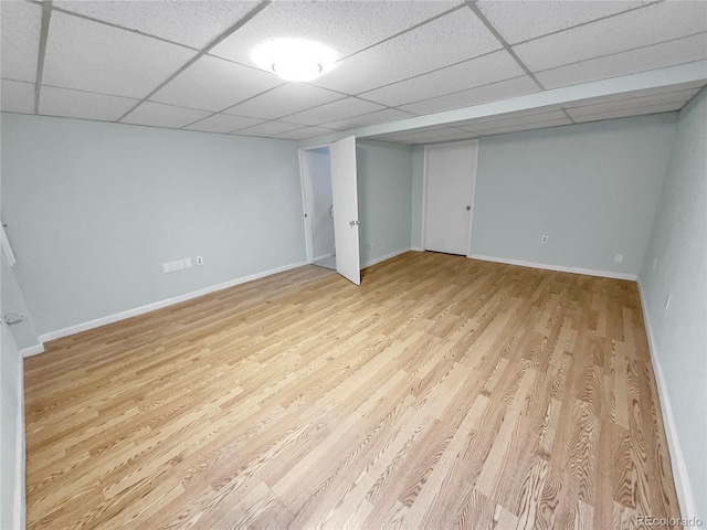 basement with light wood-type flooring and a drop ceiling