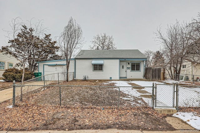 view of front of home with a gate, a fenced front yard, roof with shingles, concrete driveway, and an attached garage