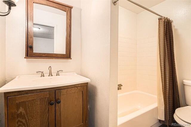bathroom with vanity, shower / bath combo, and toilet