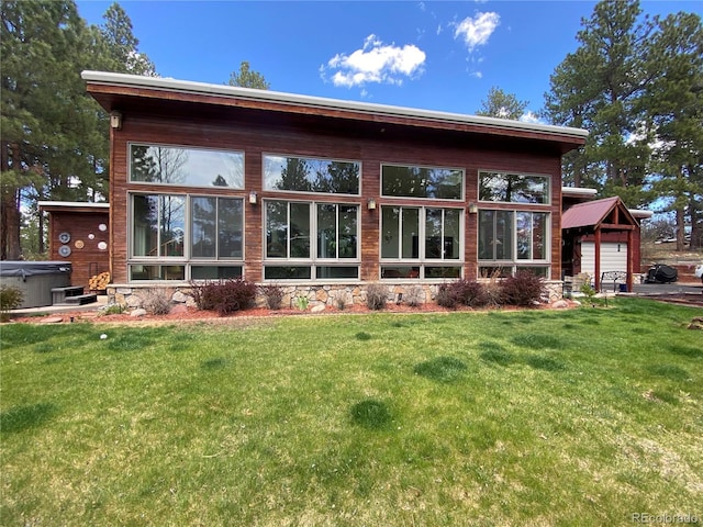 720 N Bluff Dr, Franktown, CO 80116 - back of house with a yard, a garage, stone siding, and a hot tub