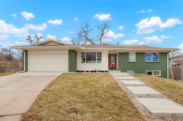 ranch-style house featuring a garage and a front yard