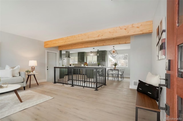 living room featuring beam ceiling and hardwood / wood-style floors