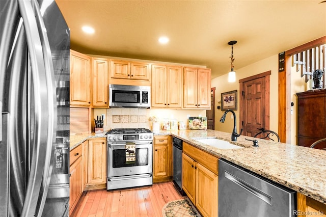2891 Nugget Rd, Fairplay, CO 80440 - kitchen with appliances with stainless steel finishes, a sink, light brown cabinets, light stone countertops, and light wood finished floors