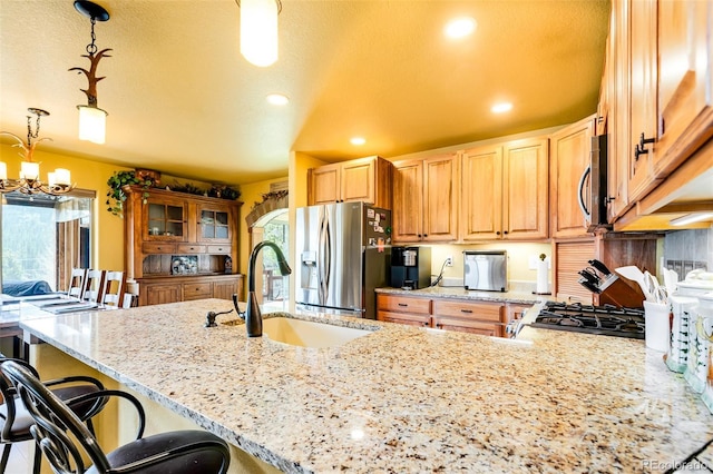 2891 Nugget Rd, Fairplay, CO 80440 - kitchen with stainless steel appliances, a sink, light stone counters, a kitchen breakfast bar, and recessed lighting
