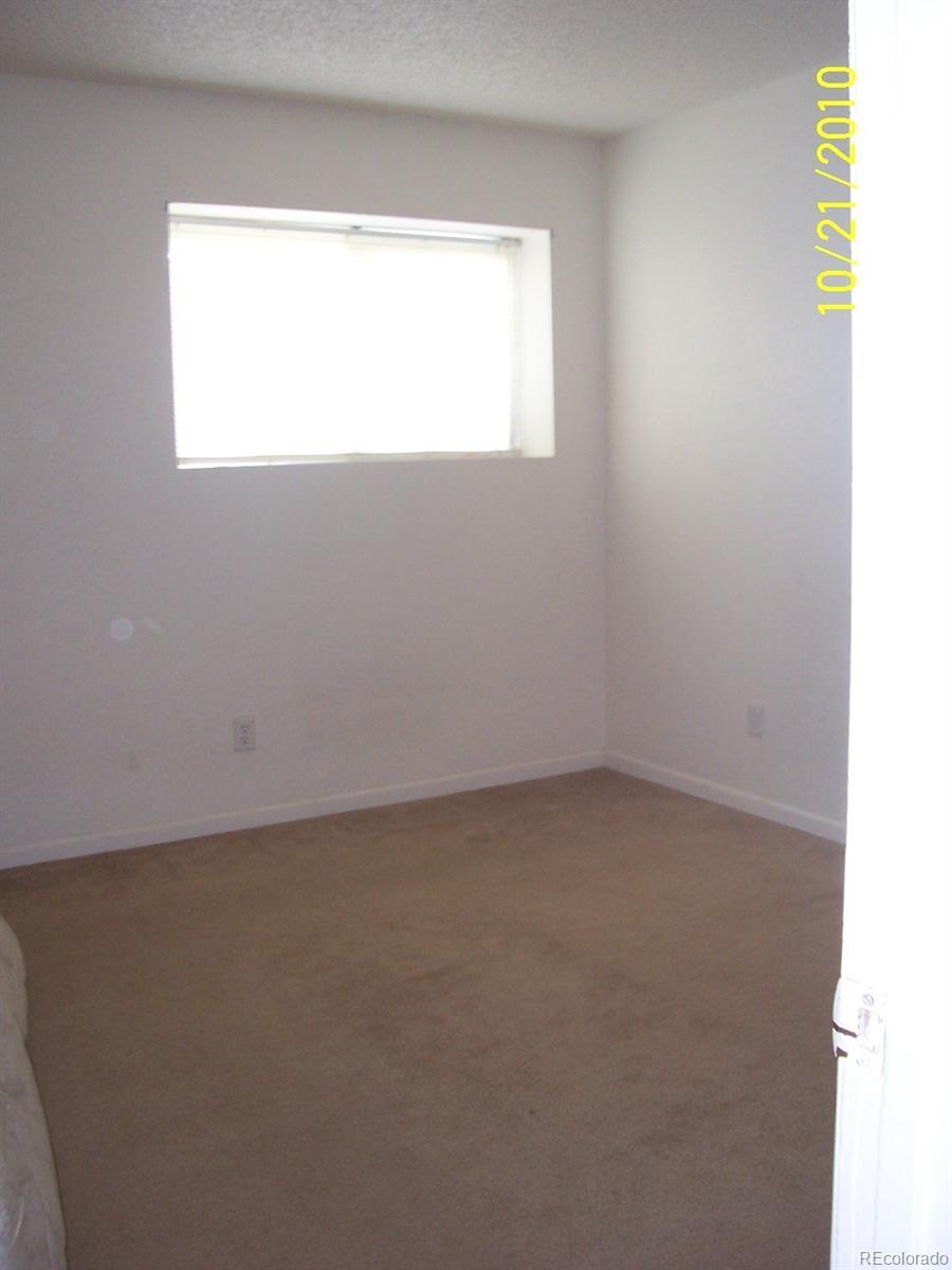 10742 E Exposition Ave Unit 124, Aurora, CO 80012 - spare room featuring baseboards and carpet floors