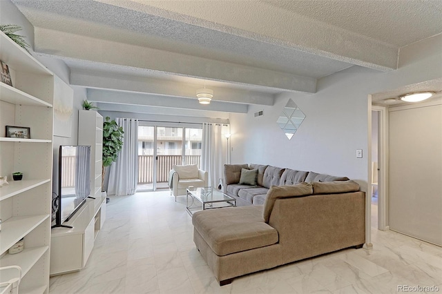 living room featuring a textured ceiling, light tile patterned floors, and beamed ceiling