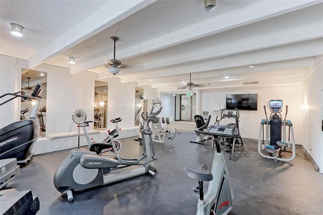 workout area featuring ceiling fan and a textured ceiling