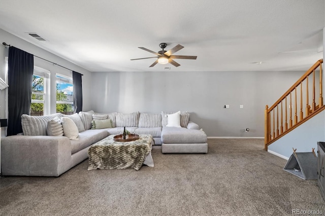 carpeted living room with a ceiling fan, stairs, and baseboards