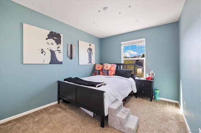 bedroom featuring carpet floors and baseboards