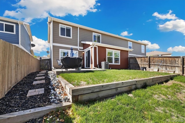 rear view of house with central AC and a patio
