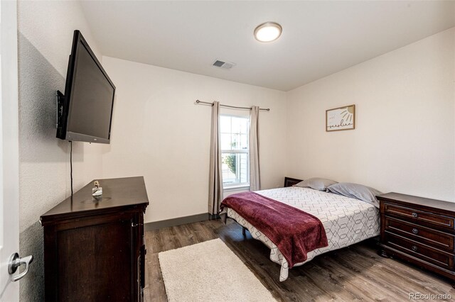 bedroom featuring dark hardwood / wood-style flooring