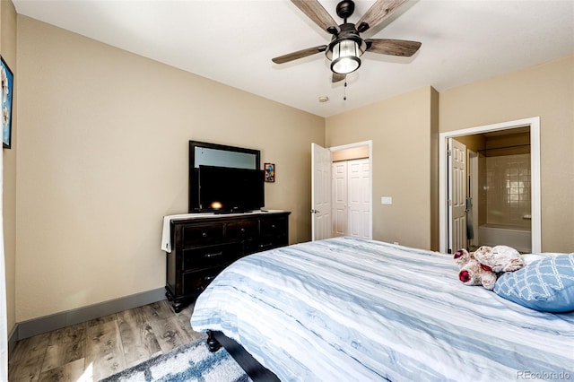 bedroom with a closet, ceiling fan, light hardwood / wood-style flooring, and ensuite bath