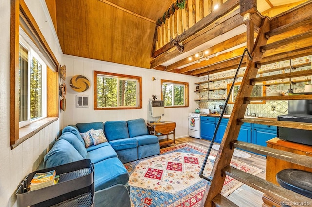 495 Georgia Pass, Jefferson, CO 80456 - living area featuring wood finished floors, wood walls, and beam ceiling