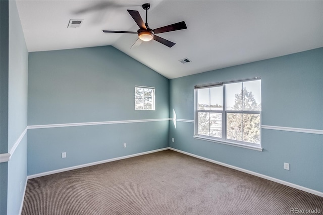 spare room featuring ceiling fan, lofted ceiling, carpet floors, and a wealth of natural light