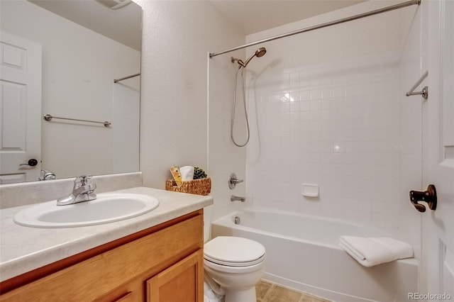 full bathroom featuring tiled shower / bath combo, vanity, and toilet