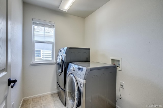 clothes washing area with separate washer and dryer