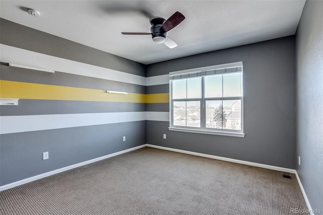 carpeted empty room featuring ceiling fan