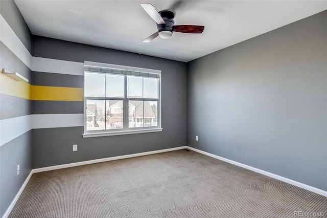 carpeted empty room featuring ceiling fan