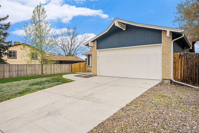 7005 Zenobia Pl, Westminster, CO 80030 - view of side of property with concrete driveway, brick siding, and fence