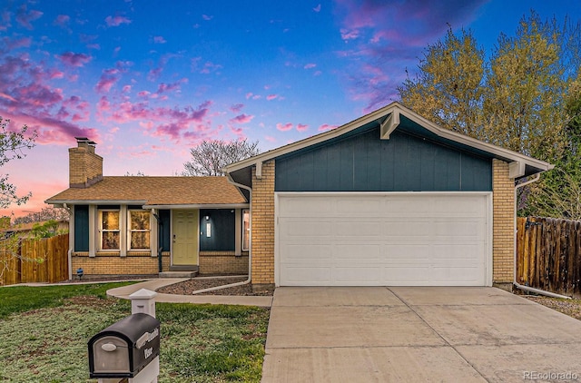 7005 Zenobia Pl, Westminster, CO 80030 - view of front of property with fence, brick siding, a garage, a chimney, and concrete driveway